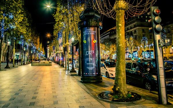 A vibrant Parisian boulevard at night, illuminated by colorful lights, lined with trees and bustling with activity, showcasing the charm of France in a stunning 4K Ultra HD wallpaper.