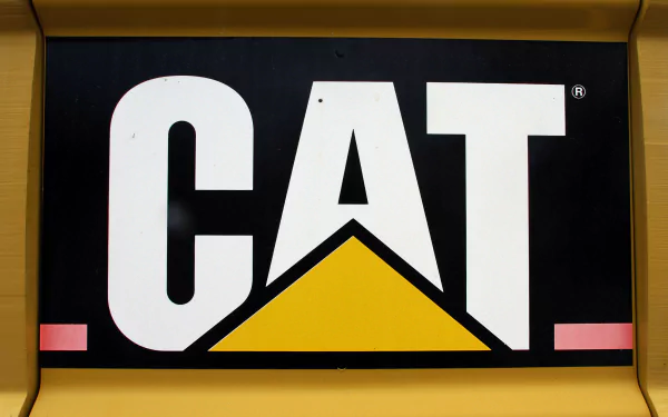 Close-up of the black, white, and yellow CAT logo on a Caterpillar Inc. vehicle, featured as a 4K Ultra HD PC desktop wallpaper and background.