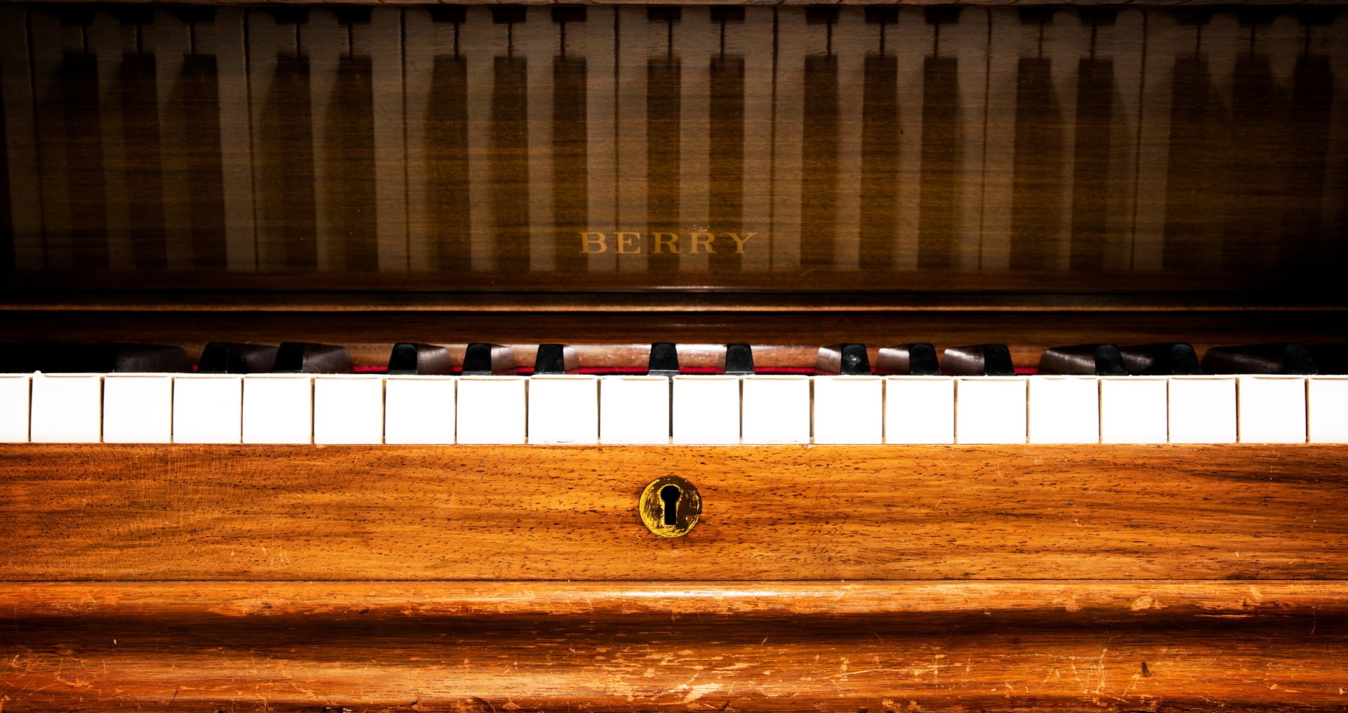Close-up of an antique wooden piano keyboard with BERRY nameplate — music, piano; 2K Quad HD PC desktop wallpaper and background.