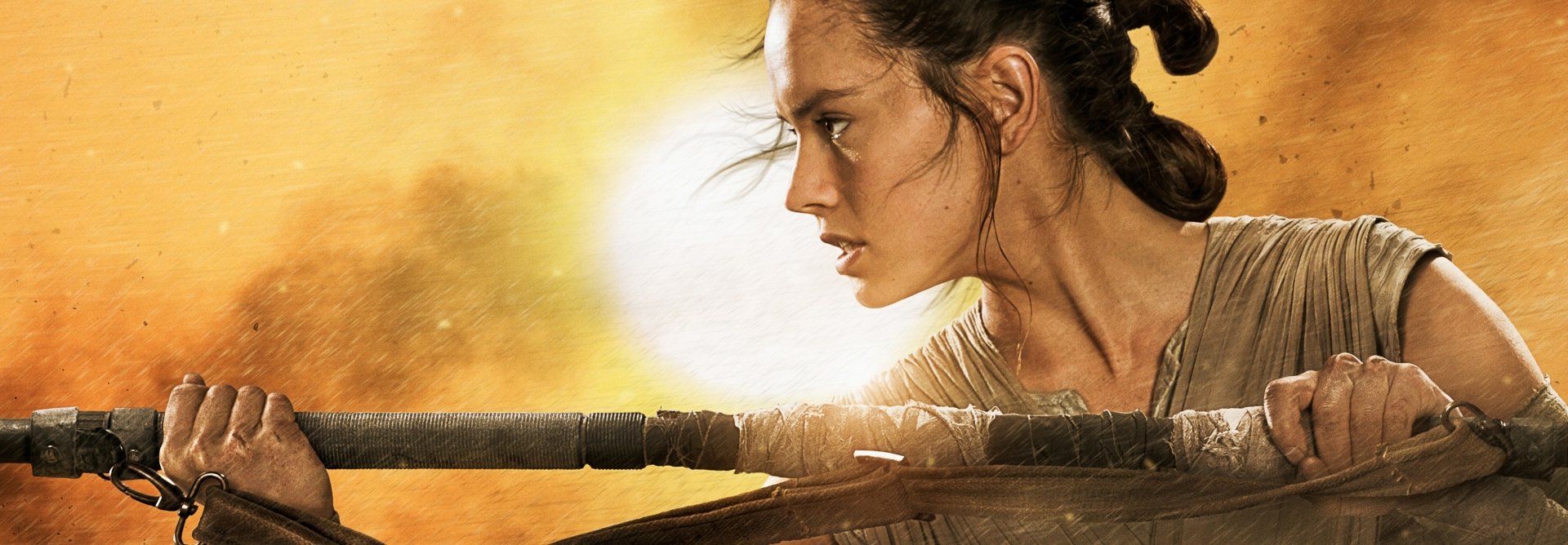 Daisy Ridley as Rey in Star Wars: Episode VII - The Force Awakens, depicted in an intense moment, ready for action against a vibrant, dynamic background. HD desktop wallpaper.