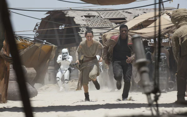 Finn (John Boyega) and Rey (Daisy Ridley) run from a stormtrooper in a desert scene from Star Wars Episode VII: The Force Awakens, shown in 4K Ultra HD.