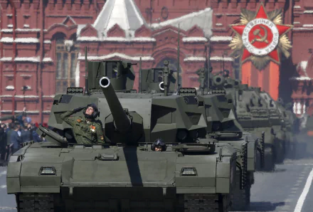 4K Ultra HD desktop wallpaper showing a T-14 Armata military tank in formation during a parade with historic red brick buildings and Soviet insignia in the background.