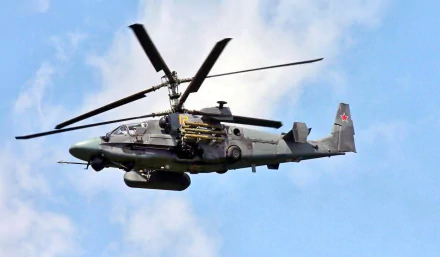 A Kamov Ka-50 or Ka-52 Alligator military helicopter hovers in the sky, showcasing its sleek design and powerful features. This high-definition image serves as a striking desktop wallpaper.