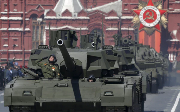 4K Ultra HD desktop wallpaper showing a T-14 Armata military tank in formation during a parade with historic red brick buildings and Soviet insignia in the background.