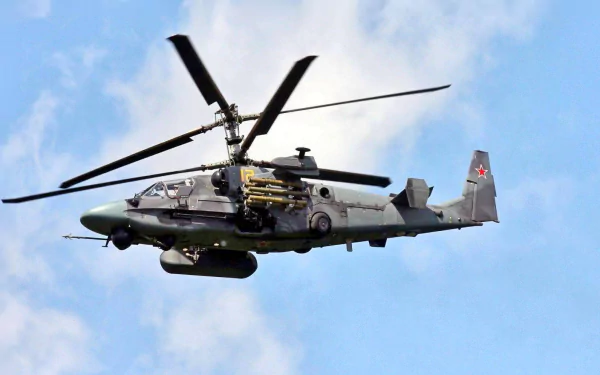 A Kamov Ka-50 or Ka-52 Alligator military helicopter hovers in the sky, showcasing its sleek design and powerful features. This high-definition image serves as a striking desktop wallpaper.