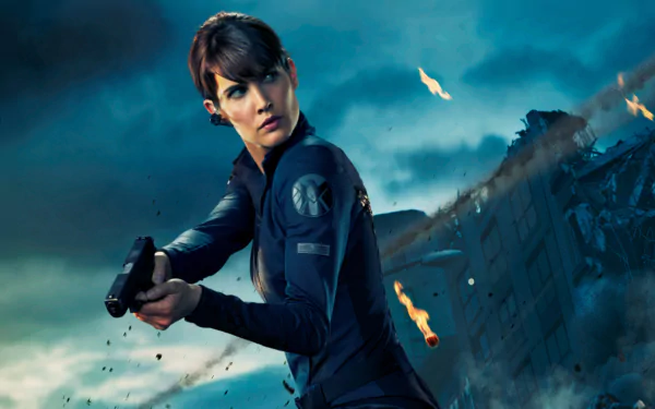 Maria Hill, portrayed by Cobie Smulders, is depicted in this dynamic HD wallpaper from the Avengers movie, showcasing action and intensity amidst a chaotic background.