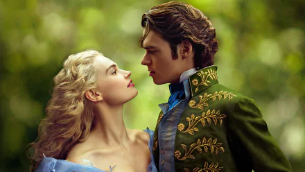 A romantic moment between Richard Madden and Lily James from the 2015 movie Cinderella, capturing their enchanting connection in a lush green backdrop. HD desktop wallpaper.