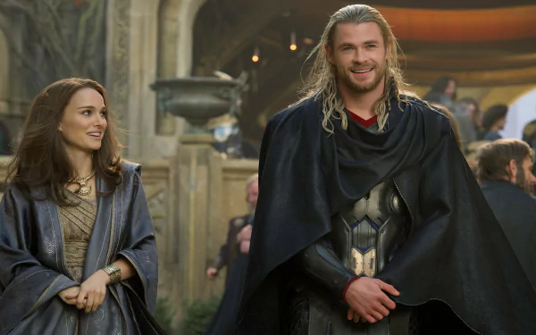 Chris Hemsworth as Thor stands smiling alongside another character in a scene from Thor: The Dark World, captured in this striking HD desktop wallpaper.