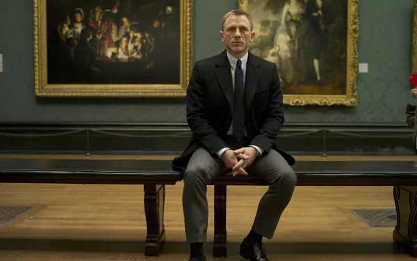 HD desktop wallpaper featuring Daniel Craig as James Bond from the movie Skyfall, seated in a museum setting with classic paintings in the background.