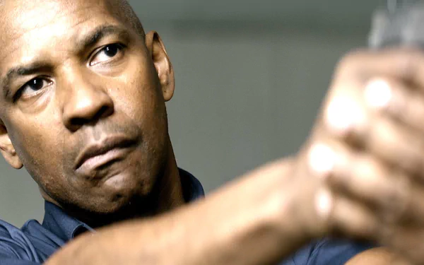 Close-up of a determined man aiming a pistol with an intense stare; HD PC desktop wallpaper background themed on the movie The Equalizer.