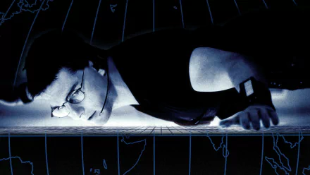 HD PC desktop wallpaper of a spy suspended horizontally over a high-tech grid in moody blue tones, evoking a Mission: Impossible movie scene.