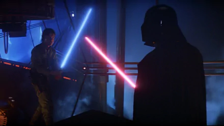 A dramatic scene from Star Wars Episode V: The Empire Strikes Back, featuring Luke Skywalker wielding a blue lightsaber against Darth Vader's red lightsaber, set in a dark environment.