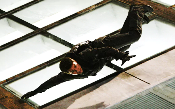 Tom Cruise in an action scene from Mission: Impossible III, captured mid-air against a glass ceiling, designed as an HD PC desktop wallpaper background.