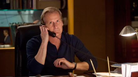 HD wallpaper of a character from The Newsroom (2012) speaking on the phone in an office setting.