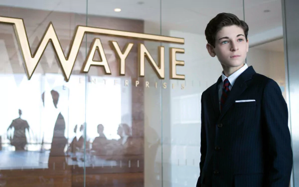 HD PC desktop wallpaper featuring a young character from Gotham TV Show standing confidently inside Wayne Enterprises lobby.