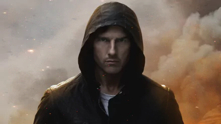 HD desktop wallpaper featuring Tom Cruise from the movie Mission: Impossible - Ghost Protocol, showcasing him intensely focused in a dark hooded outfit, against a dramatic background with smoke and clouds.