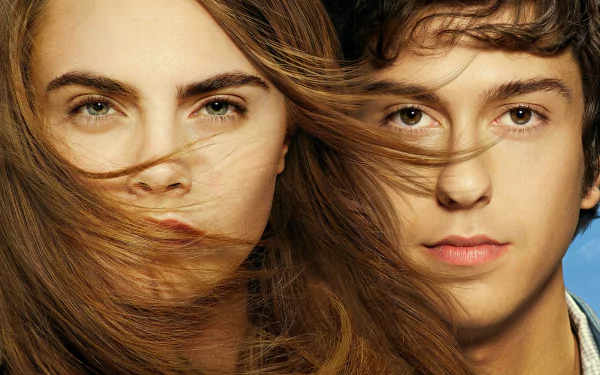 HD desktop wallpaper featuring close-up portraits of Cara Delevingne and Nat Wolff from the movie Paper Towns, with their hair gently blowing across their faces.