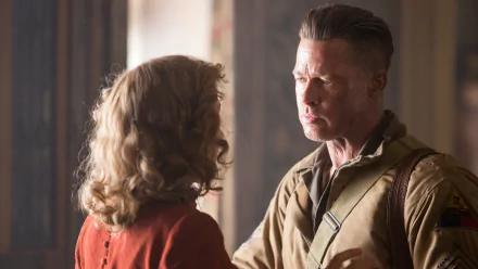 A dramatic scene from the movie Fury, featuring Brad Pitt in a tense moment. This HD wallpaper captures the emotional intensity of the film's narrative.