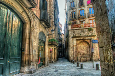 HDR image of a narrow street in Barcelona, Spain, featuring historic man-made buildings with stone facades, captured in high definition as a desktop wallpaper background.