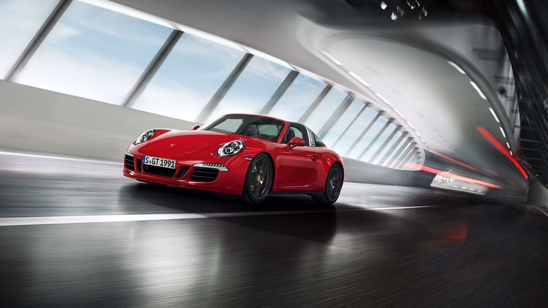 Red Porsche 911 Targa GTS sports car (Porsche 911 Targa) speeding through a glossy tunnel — 2K Quad HD PC desktop wallpaper and background.