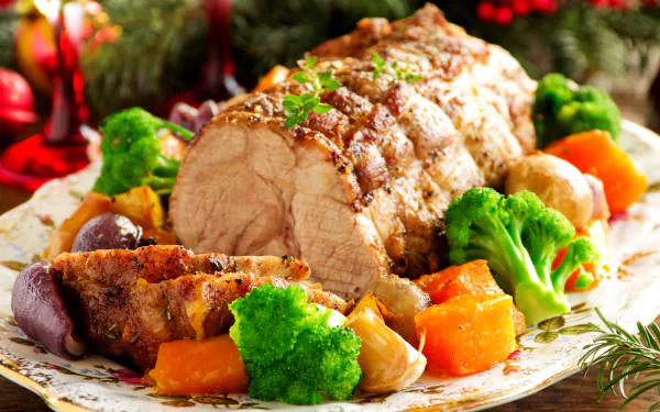 A beautifully arranged roast pork dish with vibrant broccoli, carrots, and other vegetables, perfect for a hearty meal. The image is rich in color and inviting, making it a great desktop background.