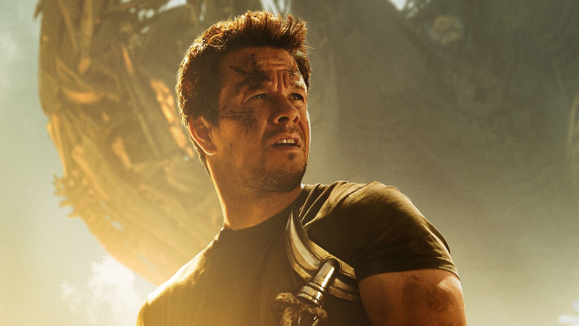 Mark Wahlberg in a dramatic scene from Transformers: Age of Extinction, featuring him against a stunning HD backdrop, capturing the intensity of the movie.