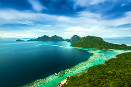 Vibrant 4K Ultra HD photography of a Malaysian island coastline: turquoise ocean, reef-fringed bays and lush green hills, panoramic PC desktop wallpaper and background.