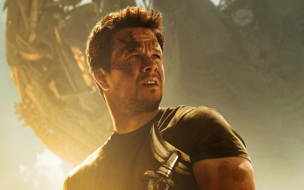 Mark Wahlberg in a dramatic scene from Transformers: Age of Extinction, featuring him against a stunning HD backdrop, capturing the intensity of the movie.