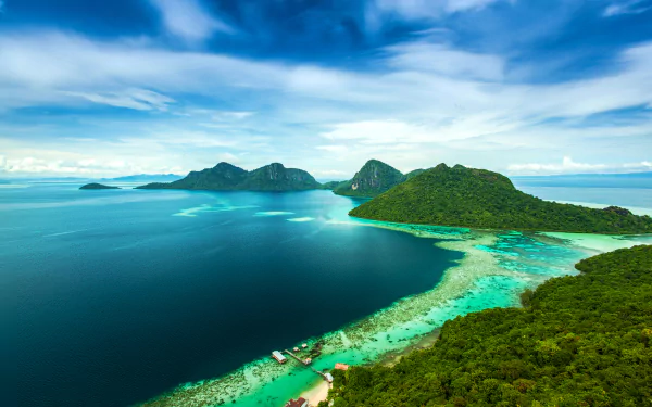 Vibrant 4K Ultra HD photography of a Malaysian island coastline: turquoise ocean, reef-fringed bays and lush green hills, panoramic PC desktop wallpaper and background.