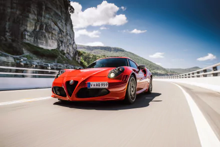 Red Alfa Romeo 4C sports vehicle driving across a coastal bridge under blue sky — high-detail 4K Ultra HD PC desktop wallpaper and background.
