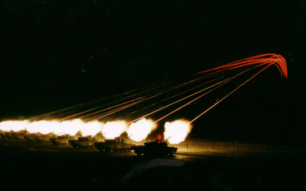 HD desktop wallpaper showing a nighttime military scene with Challenger 1 tanks firing, captured amidst bright explosions and tracer fire streaking across the dark sky.