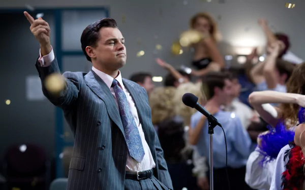 Leonardo DiCaprio as Jordan Belfort in a scene from The Wolf of Wall Street, featuring an energetic party atmosphere with confetti and celebration. High-definition desktop wallpaper.
