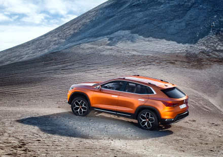 Orange SEAT 20v20 SUV parked on a rocky terrain under a bright sky, captured in 4K Ultra HD resolution for a striking desktop wallpaper background.