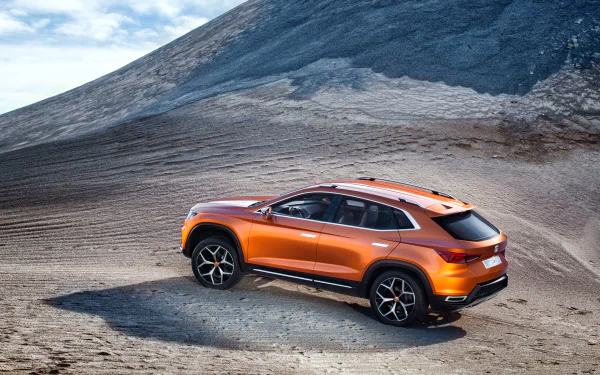 Orange SEAT 20v20 SUV parked on a rocky terrain under a bright sky, captured in 4K Ultra HD resolution for a striking desktop wallpaper background.