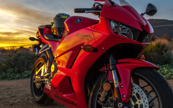 A red Honda CBR600RR motorcycle parked outdoors at sunset, captured in vivid detail for a 4K Ultra HD PC desktop wallpaper and background.