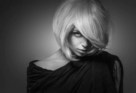 Black and white HD desktop wallpaper featuring a blonde woman model with an intense stare, partially covered by shadows and her hair.