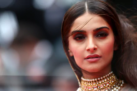 HD desktop wallpaper featuring Indian actress and celebrity Sonam Kapoor, captured in a close-up portrait with elegant makeup and sleek hair, showcasing her poised and confident expression.