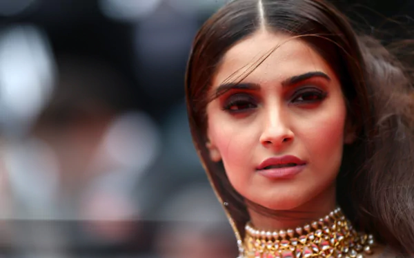 HD desktop wallpaper featuring Indian actress and celebrity Sonam Kapoor, captured in a close-up portrait with elegant makeup and sleek hair, showcasing her poised and confident expression.