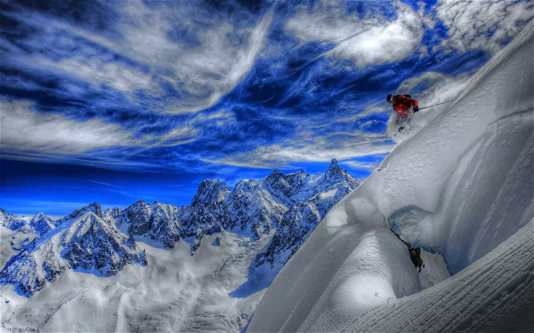 A breathtaking HDR image of a skier descending a snowy mountain, framed by a vibrant blue sky filled with dynamic clouds, capturing the essence of winter sports.