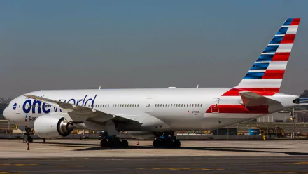 A Boeing 777 passenger plane with an One World livery parked on the tarmac, captured in high definition, showcasing its sleek design and vibrant colors.