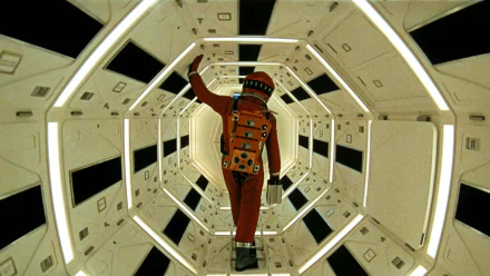 HD PC desktop wallpaper from the movie 2001: A Space Odyssey — an orange-suited astronaut walks through a white, geometric space station tunnel.