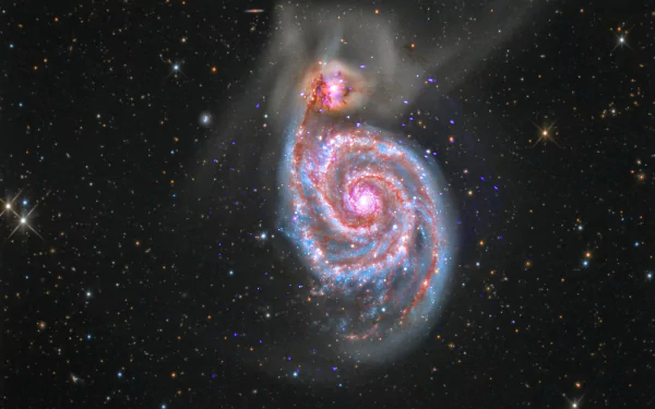 HD desktop wallpaper featuring a spiraling galaxy with twinkling stars against the dark vastness of space.