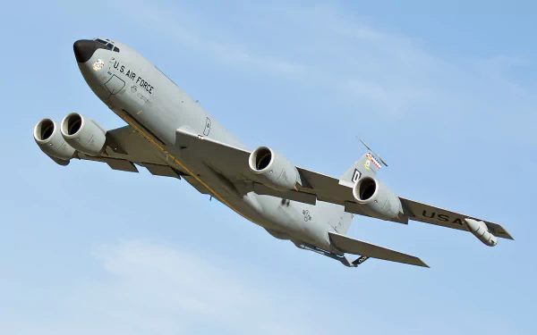 A U.S. Air Force Boeing KC-135 Stratotanker military aircraft in flight against a clear blue sky, presented as an HD PC desktop wallpaper and background.