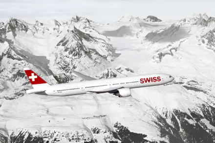 A Swiss Airlines Boeing 777 soars above the snow-capped Alps, showcasing the stunning alpine landscape in a captivating HD wallpaper.