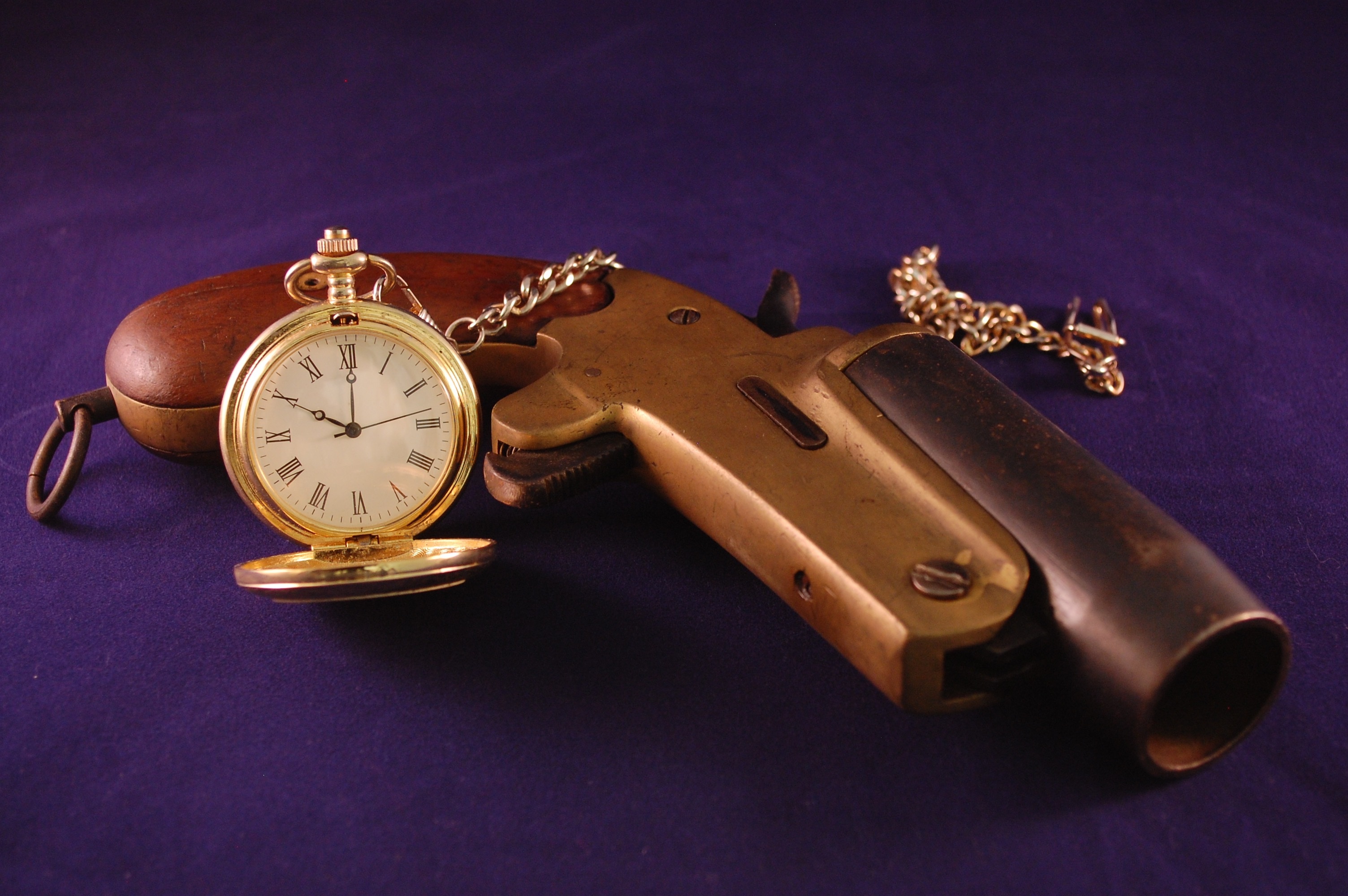Antique flare gun and pocket watch also known as a fob watch by gavilla