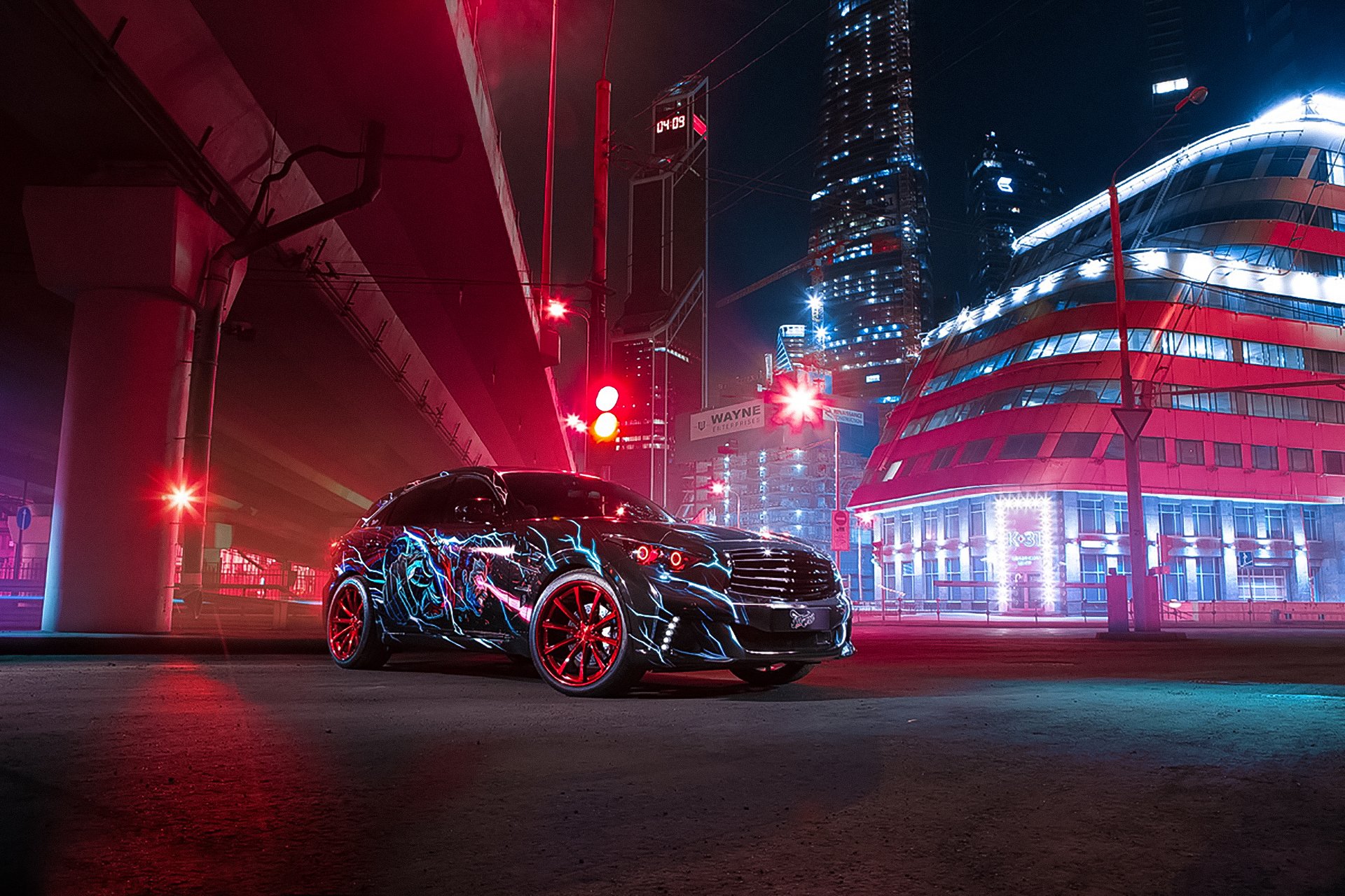 Black Infiniti QX70 SUV with vibrant graffiti design parked under a city bridge at night, illuminated by neon lights; HD desktop wallpaper and background.