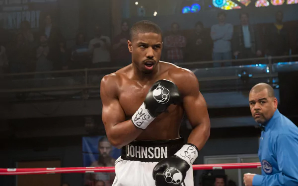 4K Ultra HD desktop wallpaper: Adonis Creed from the movie Creed — muscular boxer in the ring, gloved fists raised and intensely focused.