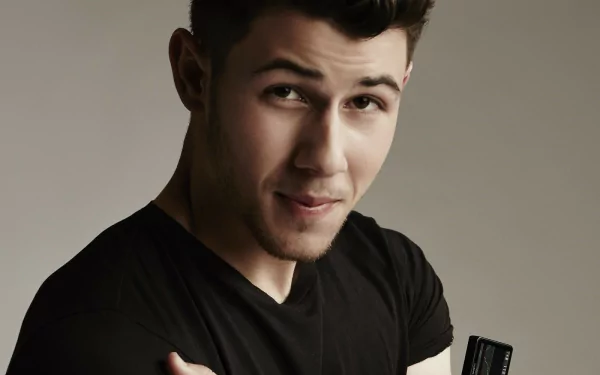 HD desktop wallpaper featuring a close-up of a person with a subtle smile, wearing a black shirt on a neutral background.