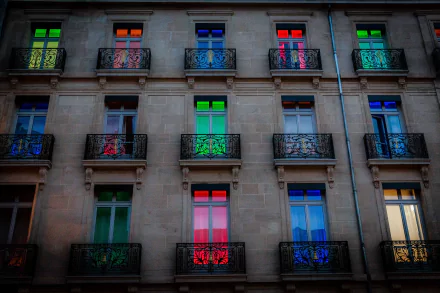 Colorful windows illuminate a hotel in Dijon, France, showcasing a vibrant display of light and color on its elegant facade. This HD wallpaper captures the essence of man-made beauty.