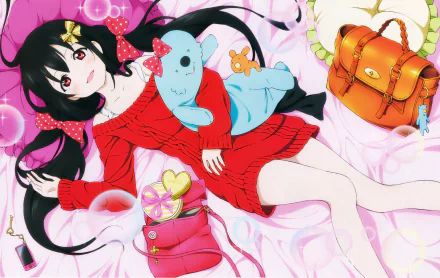 Nico Yazawa from Love Live! smiles playfully in a vibrant red sweater, surrounded by colorful pillows and bags, with twintails and a plush toy, set against a dreamy background.